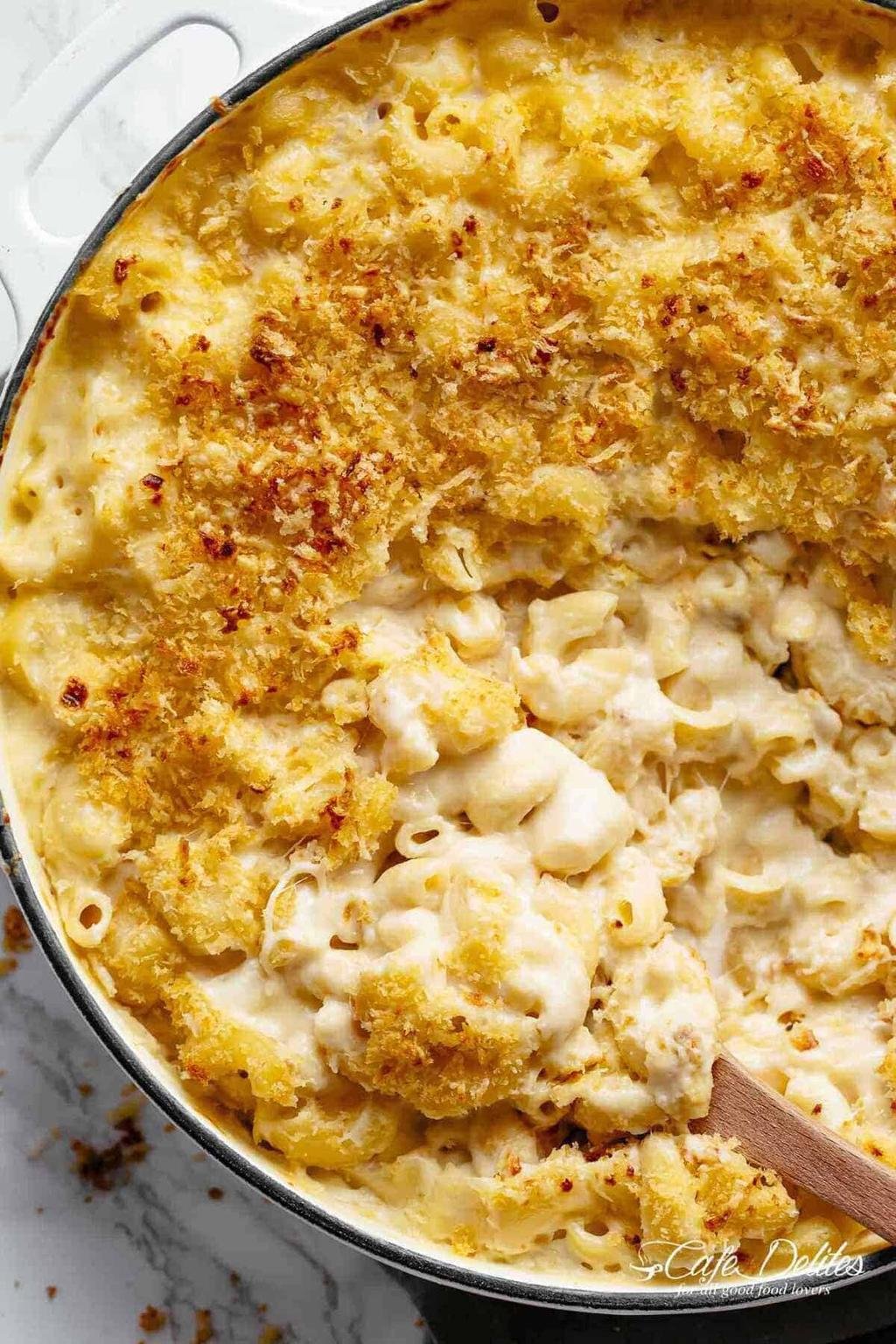 Close-up of creamy macaroni and cheese with a golden breadcrumb crust in a skillet.