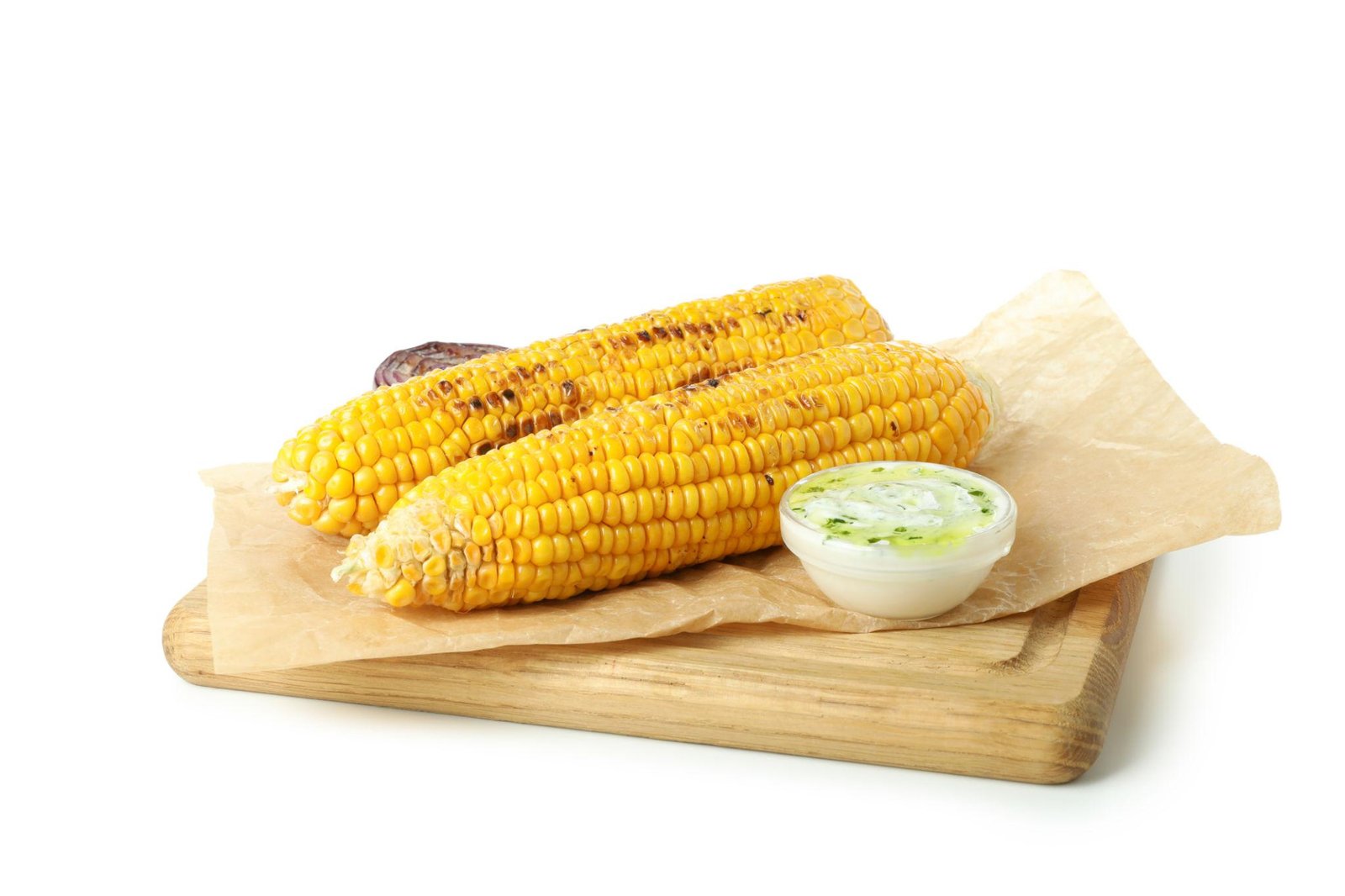 Grilled corn on the cob with a herb butter dip on a wooden serving board lined with parchment paper.
