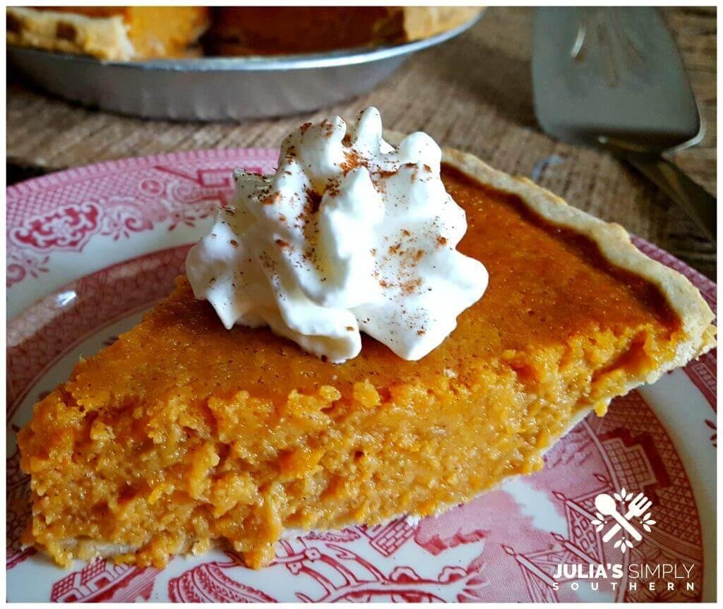 Slice of pumpkin pie with whipped cream on a pink patterned plate