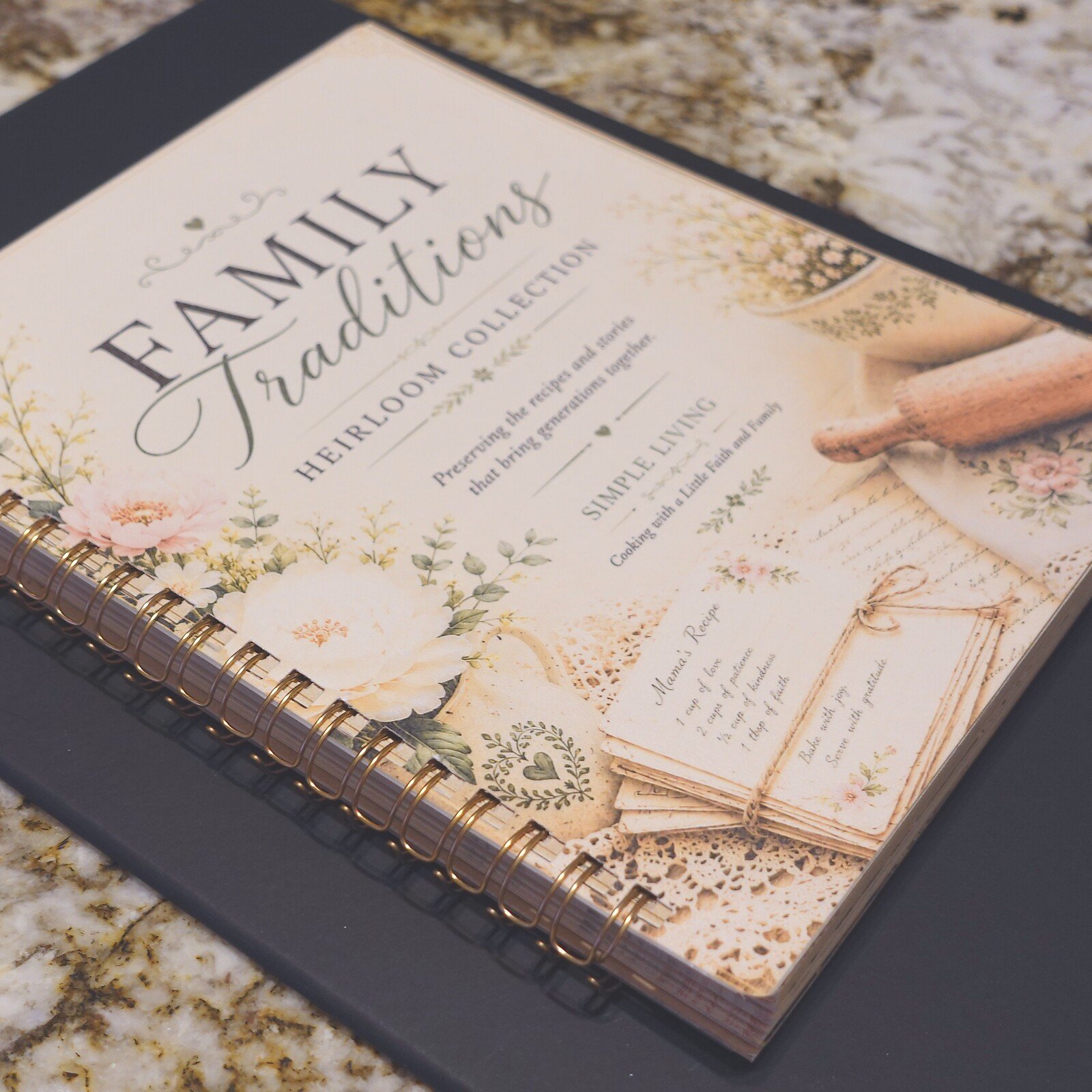 02-spiral-bound-angle - Simple Living Faith Floral-covered heirloom 'Family Traditions' album with gold spiral binding on a dark surface.